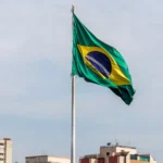 Brazilian flag waving against São Paulo skyline