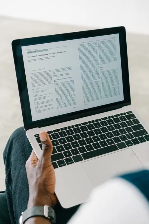 A person reviewing an official digital asset industry announcement alongside a news article on a computer screen.
