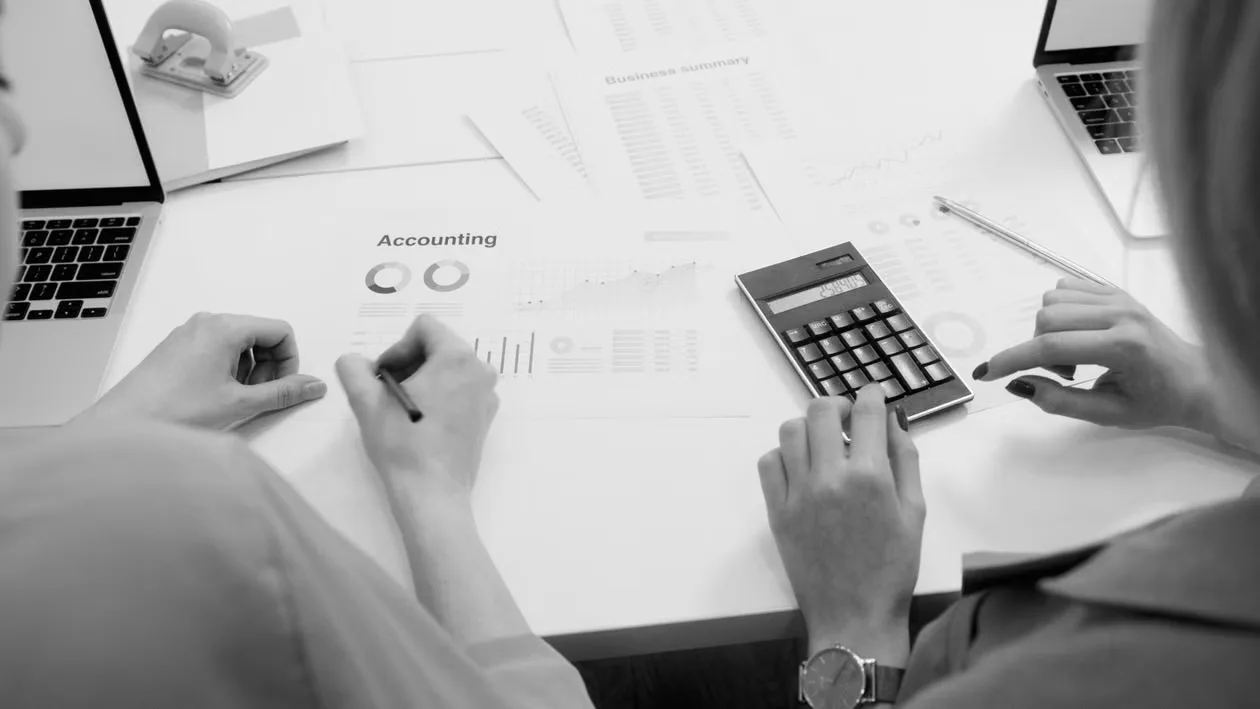 A financial reporting team reviewing digital asset records and accounting document 