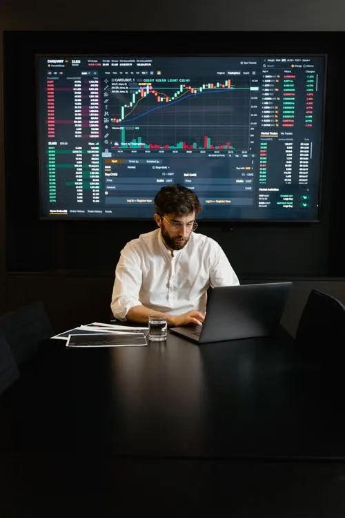 kenson Investments | How Changing Crypto Regulations Can Affect Exchange Access and Digital Asset Operations A person reviewing cryptocurrency transaction records, exchange announcements, and digital asset security information on a laptop.