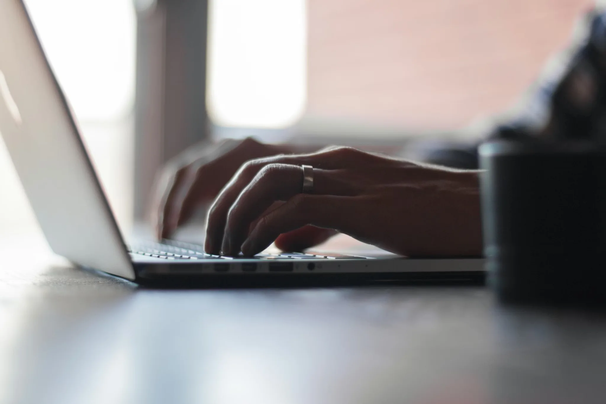 Person working on a laptop representing due diligence for digital asset trading platforms and institutional exchange selection.