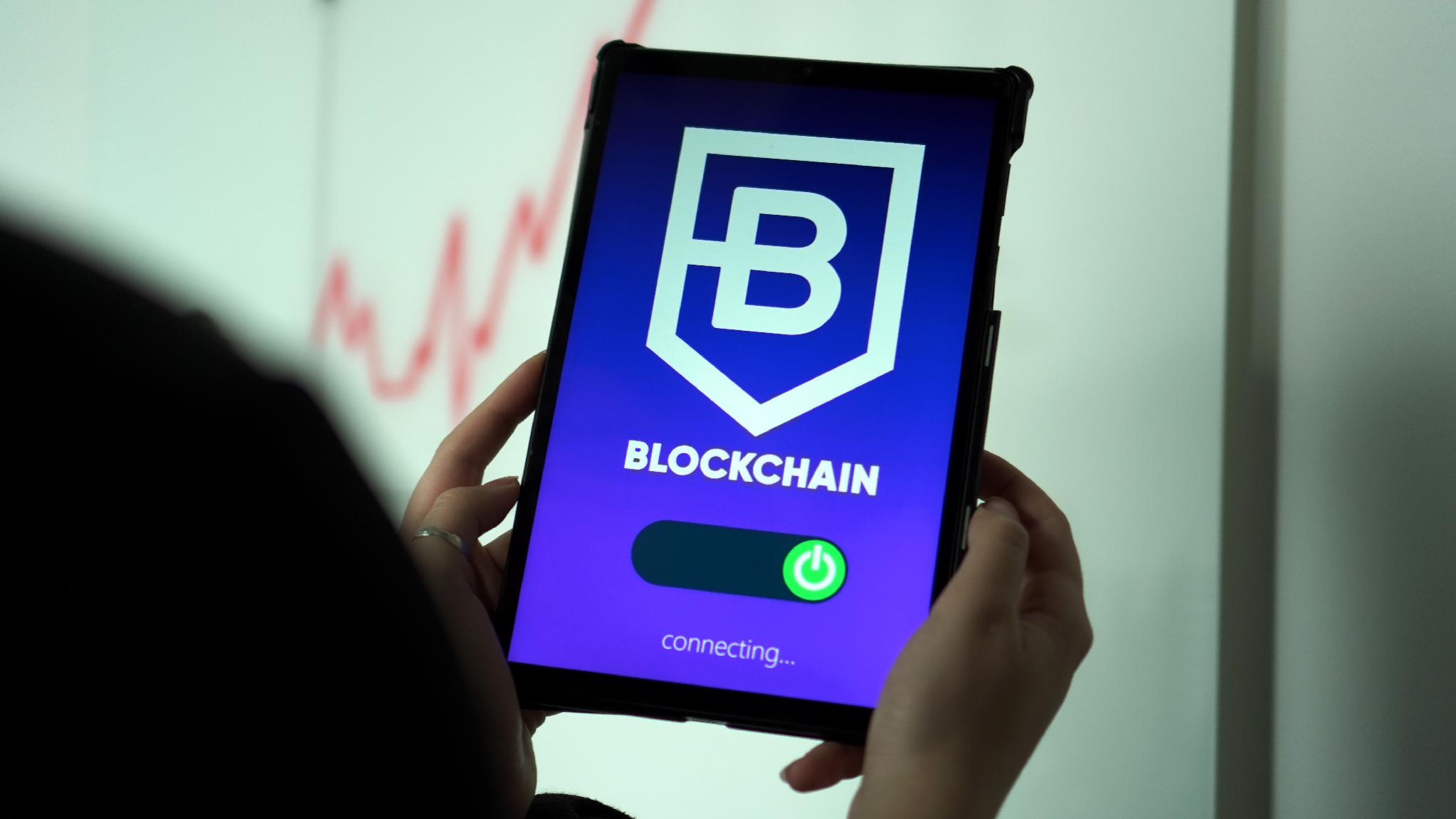 Hand holding a tablet displaying a cryptocurrency wallet representing digital asset ownership and access