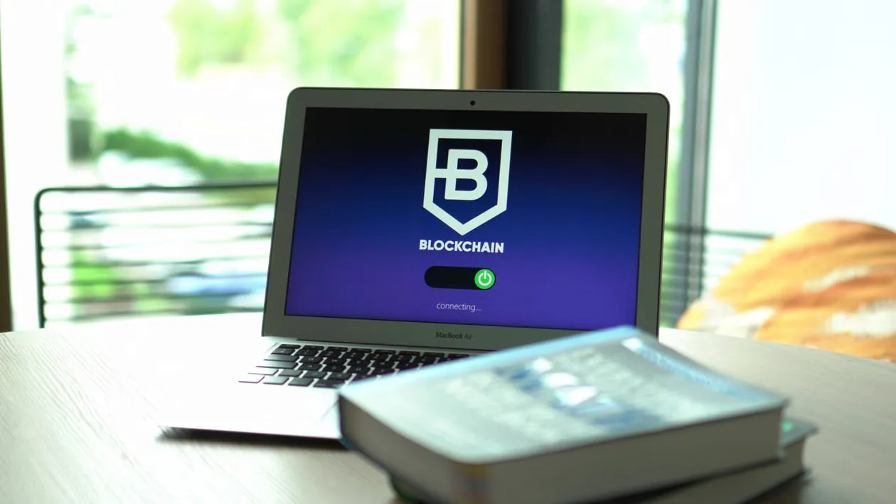 kenson Investments | Ethereum Validator Authority After Pectra: Operating, Withdrawal and Exit Powers Laptop displaying blockchain connecting screen in modern setting