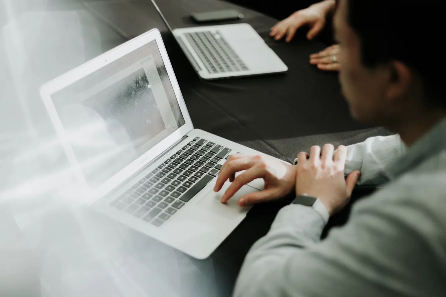 Professional using a laptop to review blockchain market activity and digital asset exchange flows.