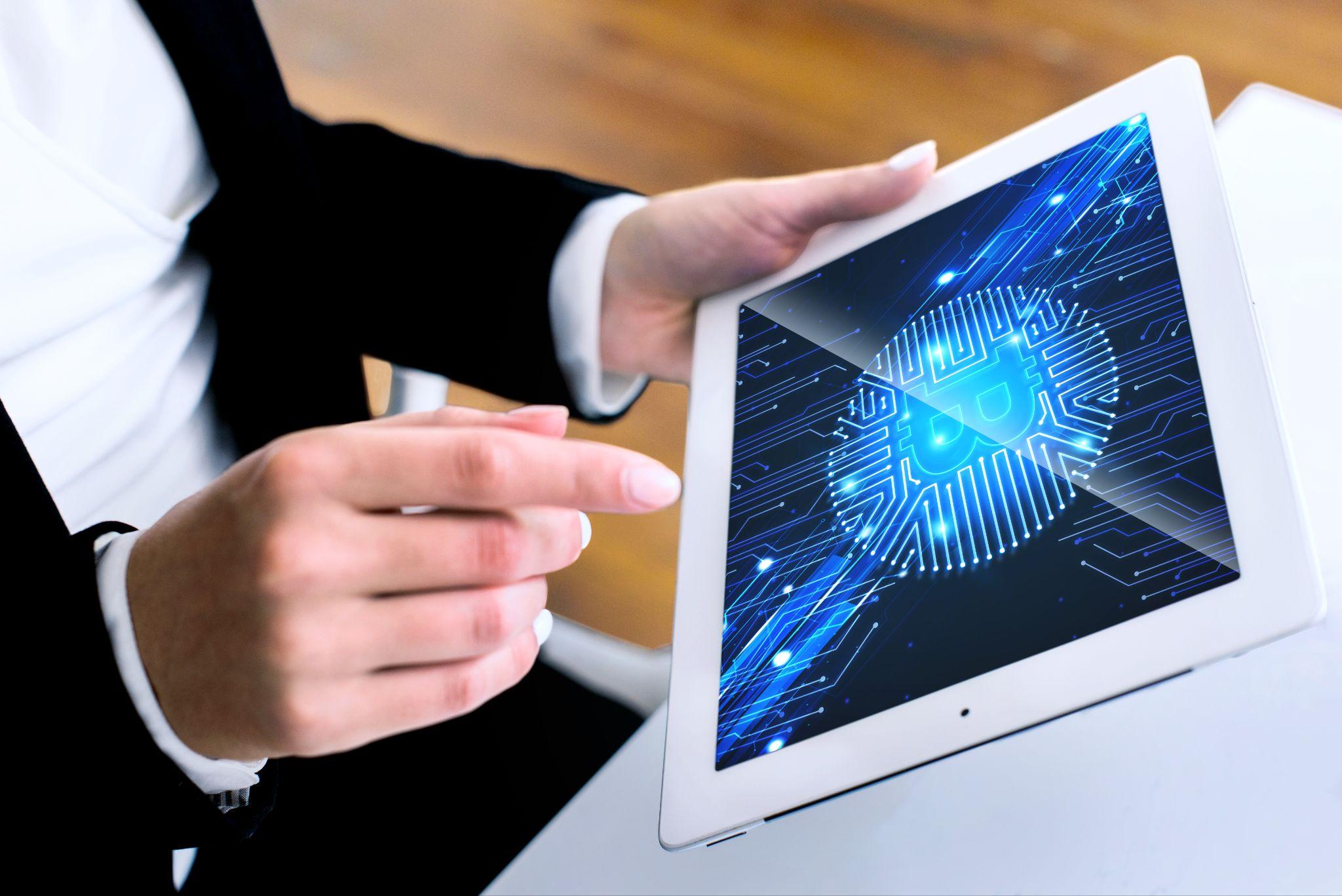 Business professional using a tablet with digital security technology representing signer roles in institutional wallet governance.