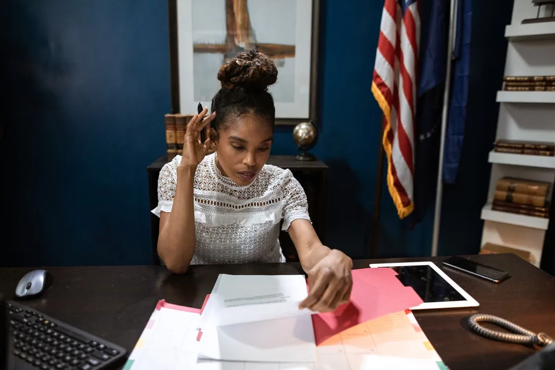 A researcher reviewing official government publications, agency announcements, rule numbers, and implementation dates
