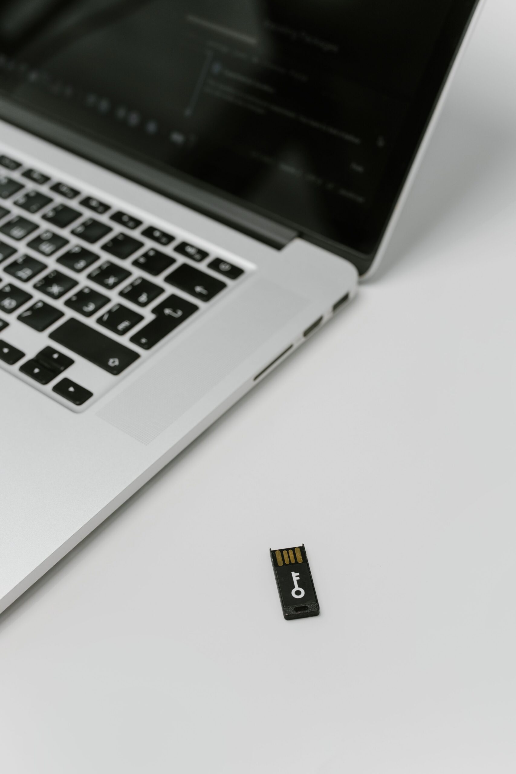 USB security key positioned beside a laptop for secure account authentication