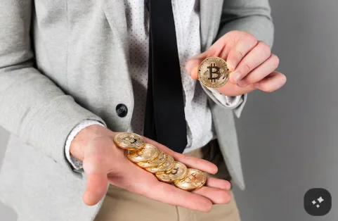 kenson Investments | Principles-Based Disclosure for Crypto Offerings: What Purchasers Would Actually Receive Close-up of a man holding a stack of golden Bitcoin coins.