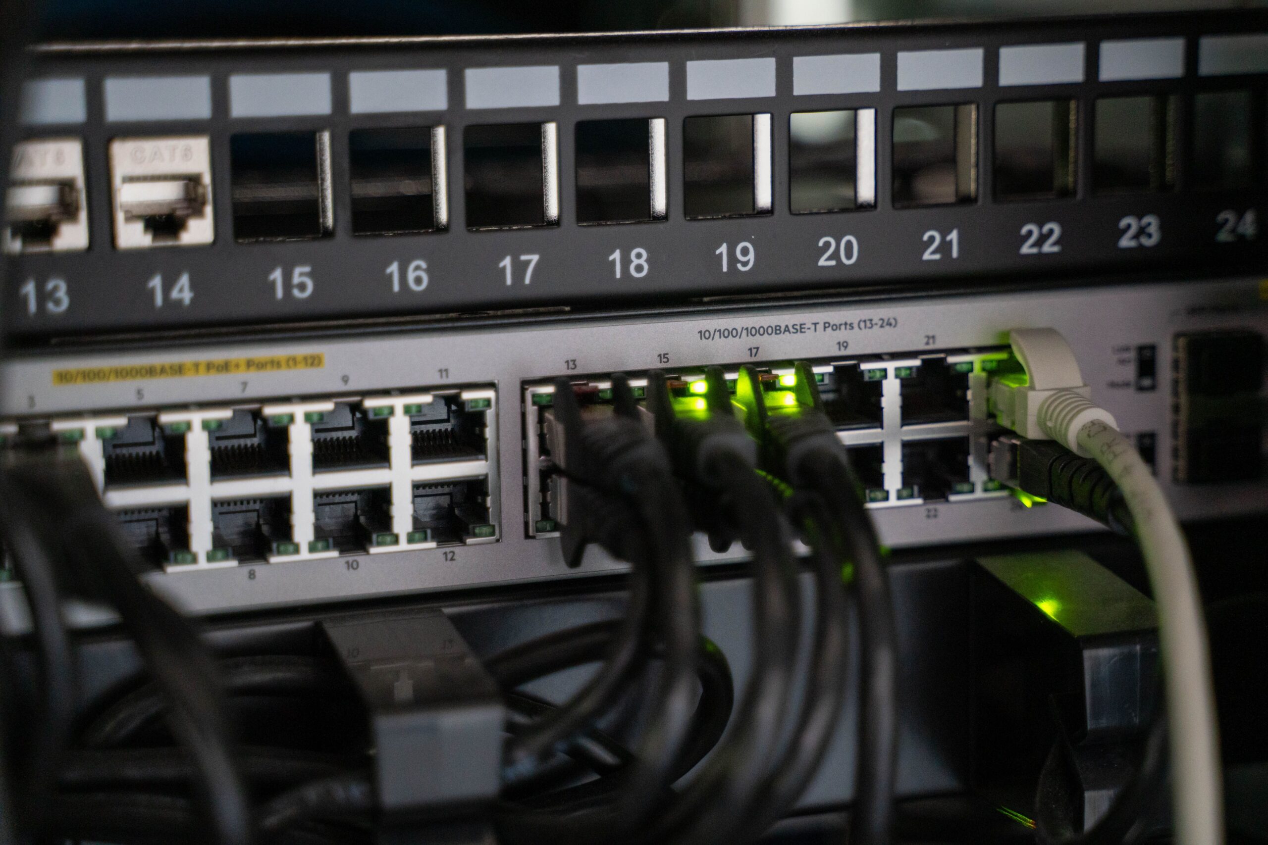 Network cables connected to infrastructure equipment representing interconnected public and permissioned blockchain systems