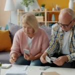 kenson Investments | Fiduciary Review of Digital and Alternative Assets in Retirement Plan Menus Senior couple reviewing household finances together indoors.