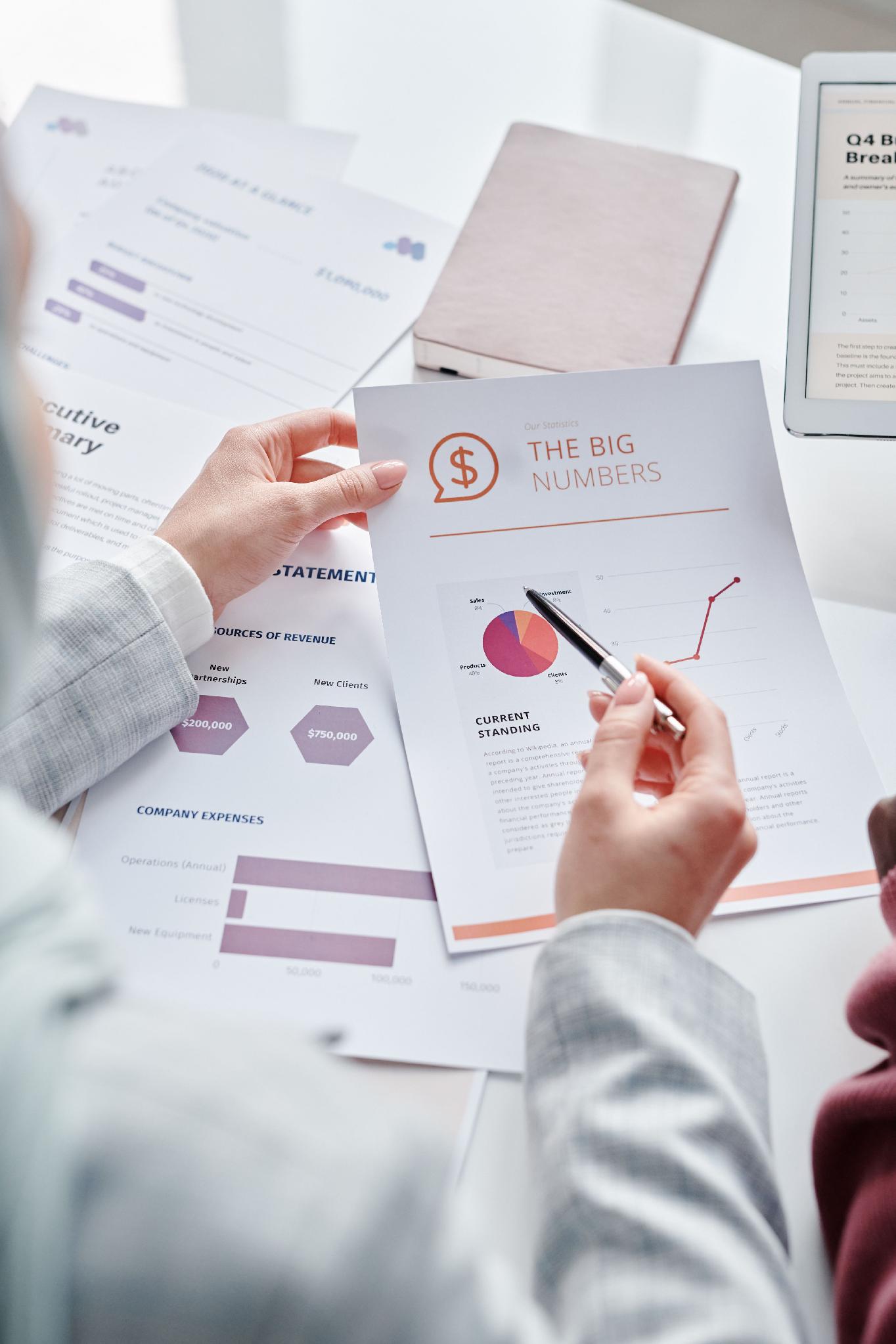 Professionals reviewing financial documents and charts during an economic analysis