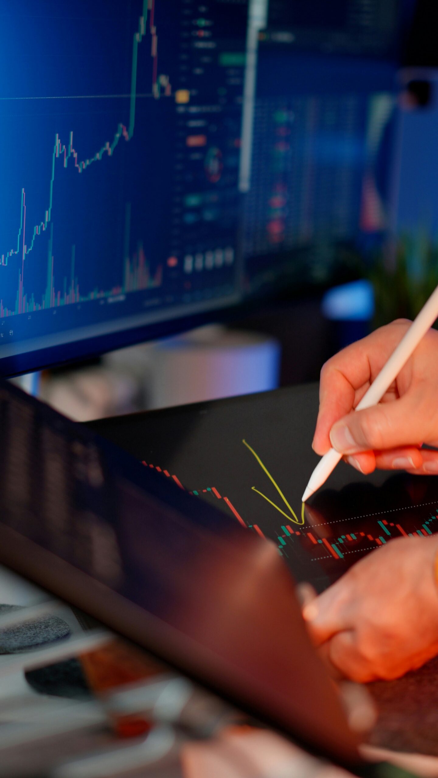Analyst reviewing financial charts and market data across multiple screens